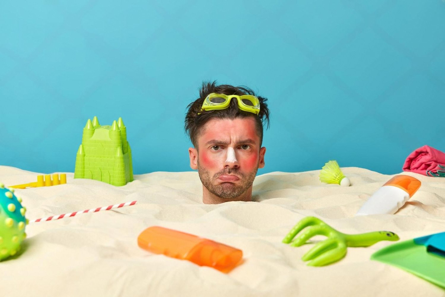 Man with red sunburned face on the beach illustrating summer skin damage in the UAE